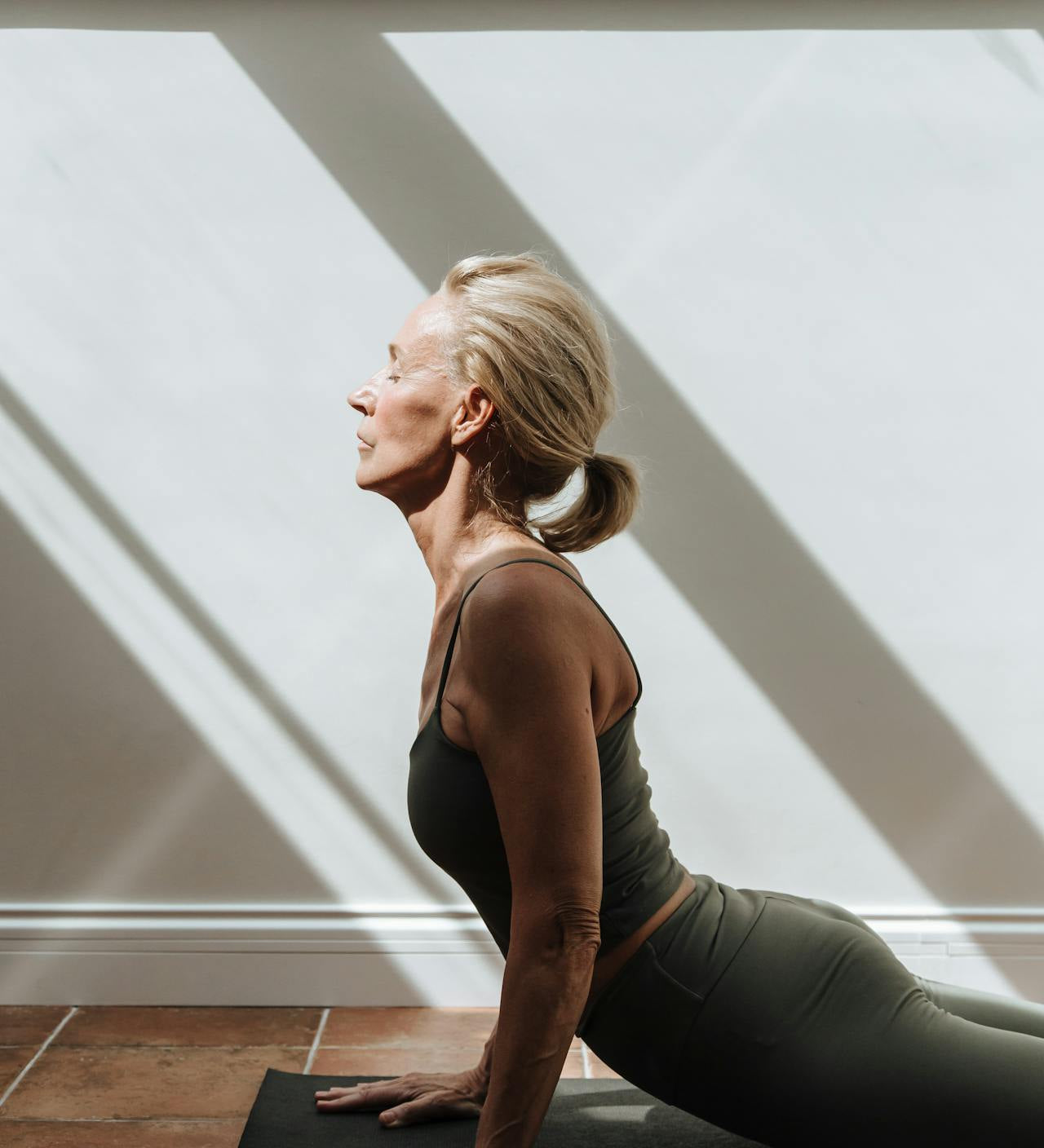 Woman over 40 stretching in workout clothes