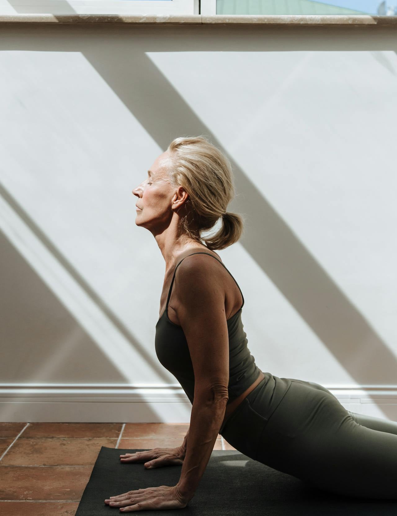 Woman over 40 stretching in workout clothes