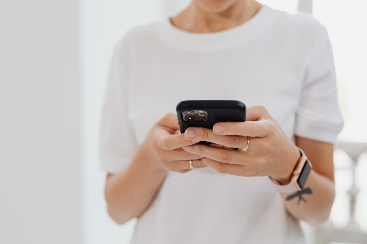 Woman holding phone, googling stress in perimenopause
