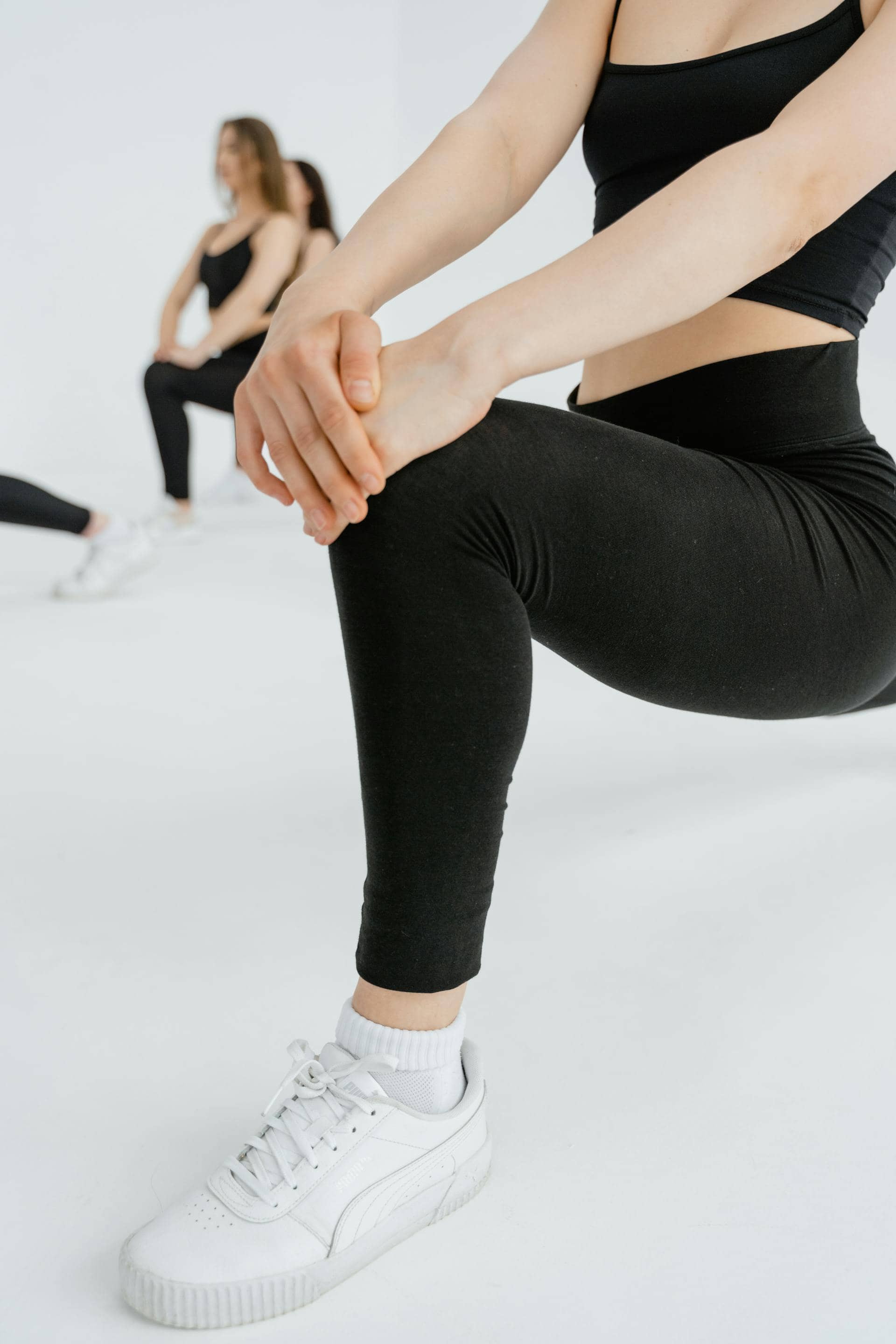 Woman in black active wear doing lunges