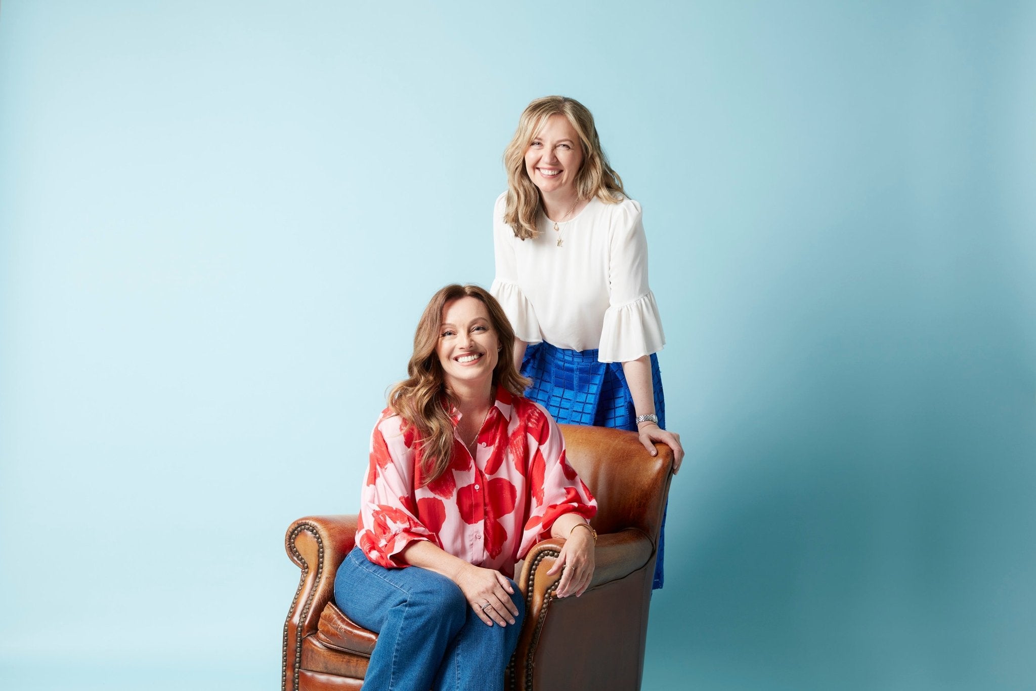 Lisa walker sitting on chair and Kate Guaran standing behind