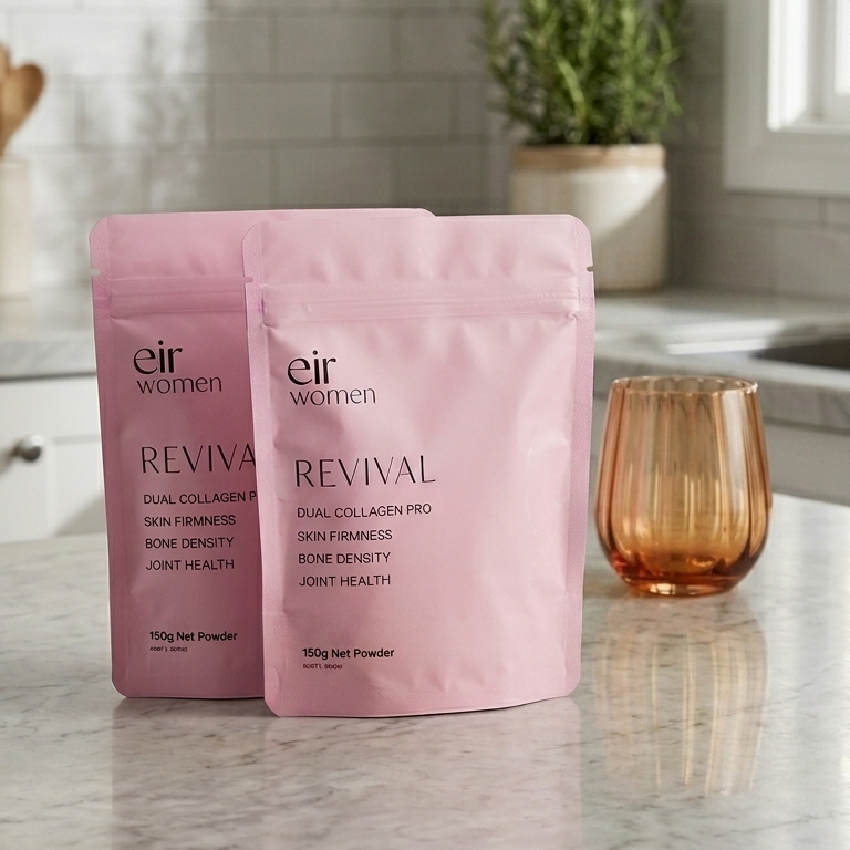 Two pink packages labeled 'Revival' on a kitchen counter with a glass of water.