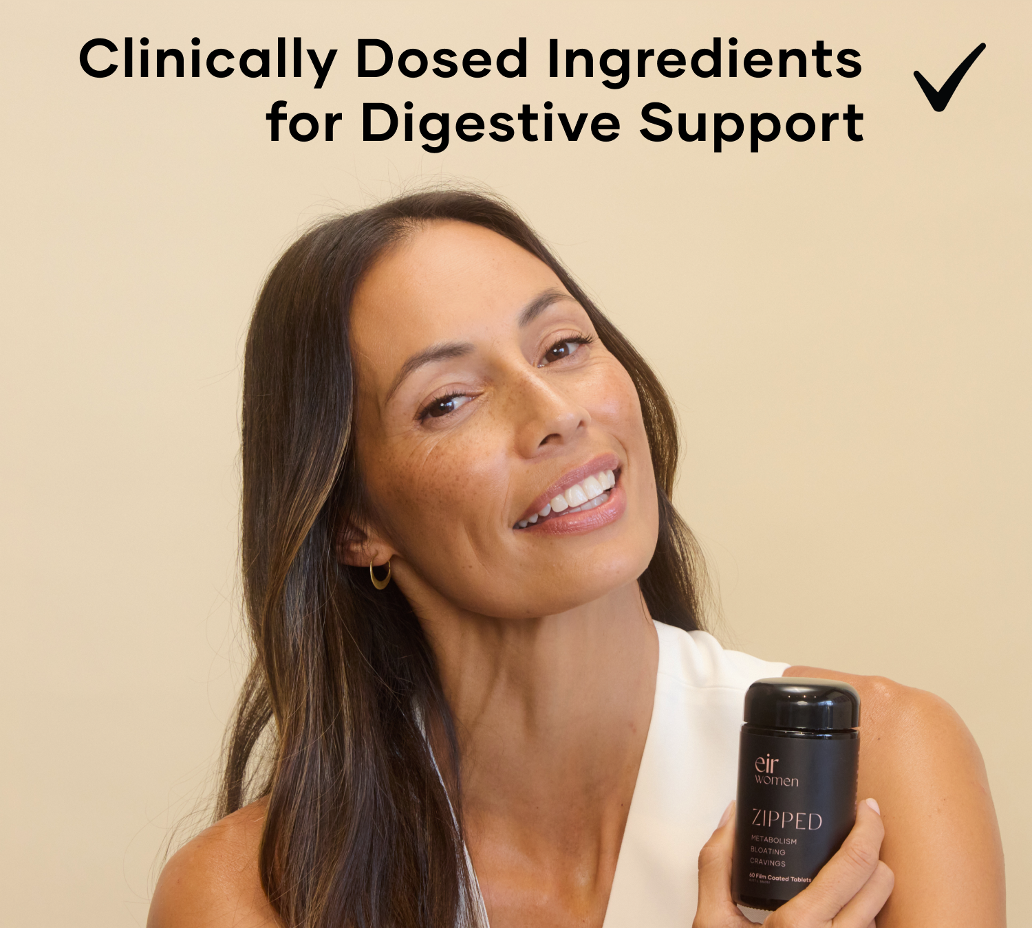 Woman holding a black glass bottle of Zipped Eir Supplement - clinically dosed ingredients for digestive support