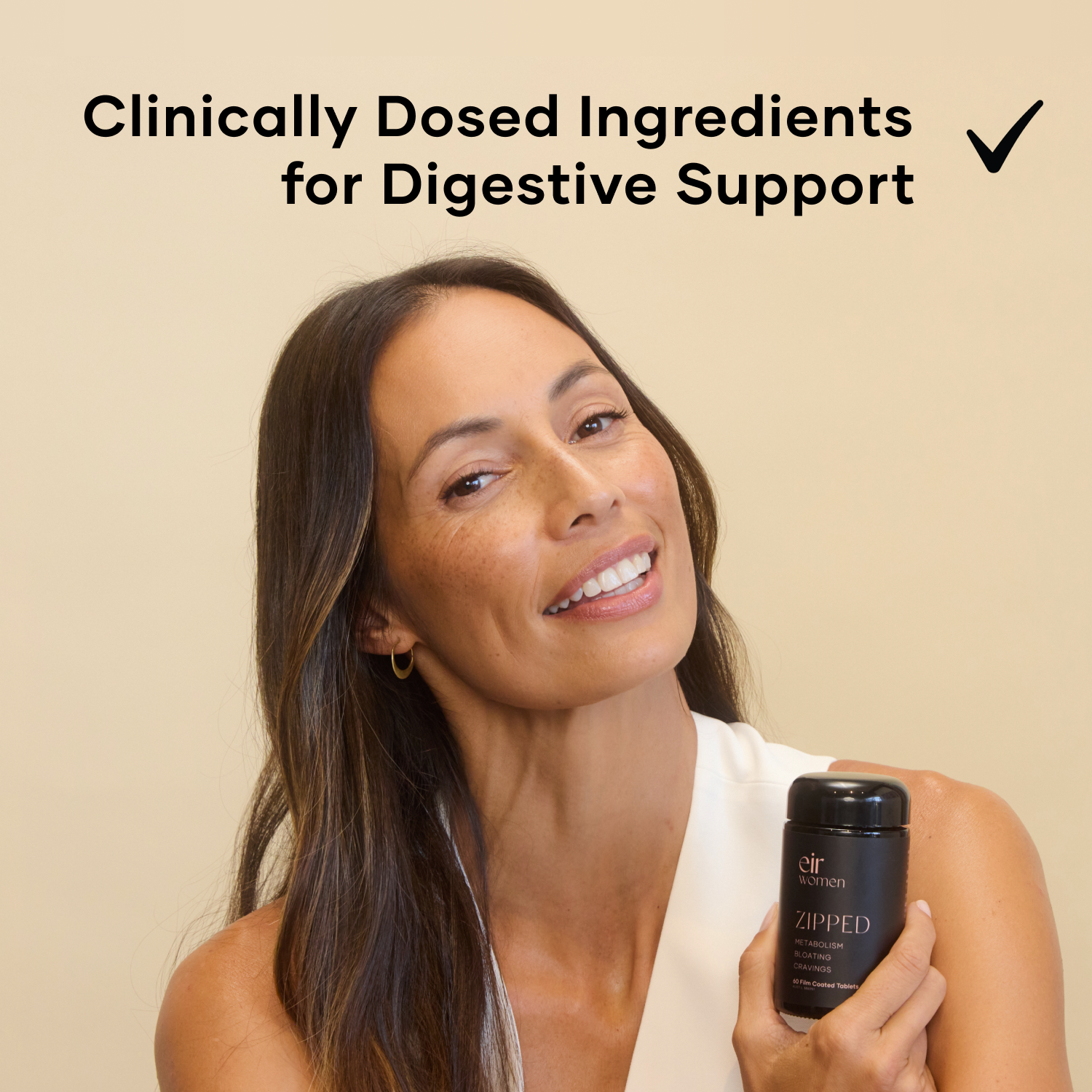 Woman holding a black glass bottle of Zipped Eir Supplement - clinically dosed ingredients for digestive support