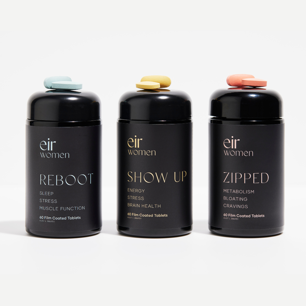 Black bottle of Reboot Eir Supplement with blue print, black bottle of Show Up Eir Supplement with yellow print, Black bottle of Zipped Eir Supplement with pink print
